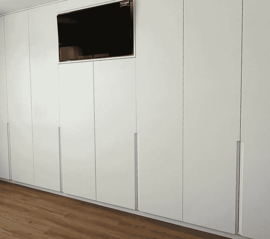 Roupeiro lacado com televisão embutida.